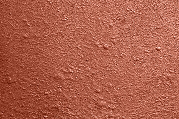 Fototapeta premium Painted metallic wall with warm red pearlescent coating, uneven surface and fine texture, abstract background for design.