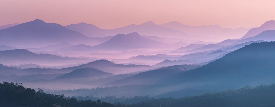 A beautiful, panoramic background of a soft, misty mountain range at dawn, with layers of peaks fading into soft, pastel colors, serene and atmospheric --ar 64:25 --v 7 Jo