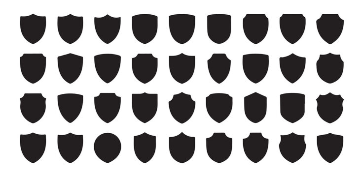 Large collection of solid black shield silhouettes for heraldic crest design and security company branding use.