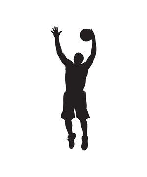 Silhouette of a basketball player jumping to shoot the ball during a game.