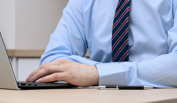 Man using technology, operating a laptop, IT specialist at work