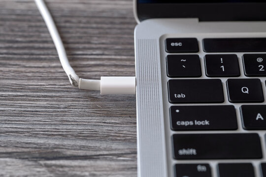 A close-up of damaged laptop charger cable. Unable to charge and use laptop.