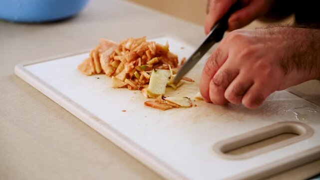 Slicing apples on a cutting board in a kitchen