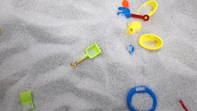Small Green Shovel on White Sand Pit