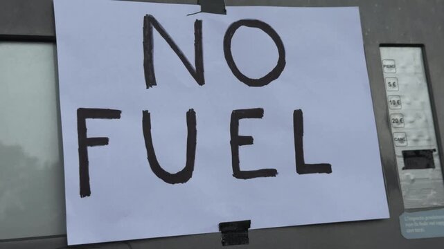 A sign has been posted at the gas pump.