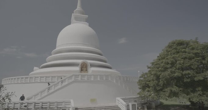 Sri Lanka, Unawatuna. Japanese Peace Temple In Rumassala, Galle, Sri Lanka. Monks walking around Famous landmark and cultural sacred place. View of the Japanese built Buddhist Temple Peace Pagoda at