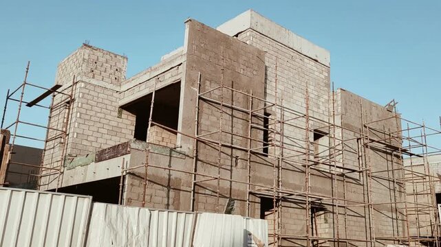 Under construction residential villas House process of being built, showcasing structural framework, raw materials, and partially completed architectural elements. Modern housing 02 Story villa's.