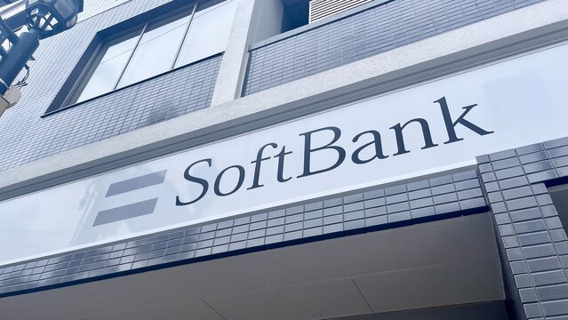 SoftBank telecommunications retail store signage located at SMBC Komagawacho Branch building with modern urban tile architecture and street lighting - Osaka, Japan, September 3, 2025