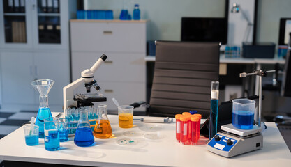 Science lab workspace with test tubes and equipment, research in action. © NINENII