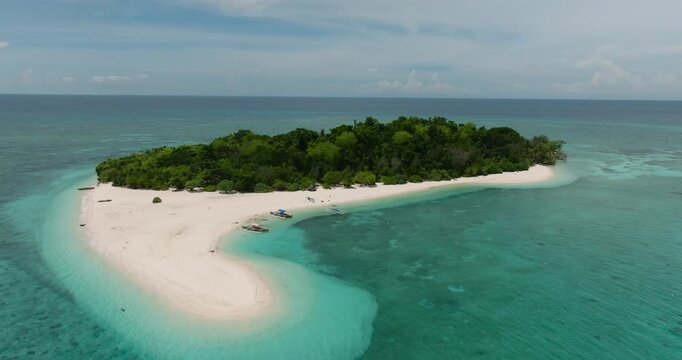 Aerial view of sandbar and white beaches in Mantigue Island. Blue sky and clouds. Camiguin, Philippines.