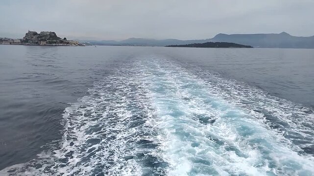 The ship moves away from the island, and only the water from under the ship beautifully churns, leaving a long, even trail on the sea