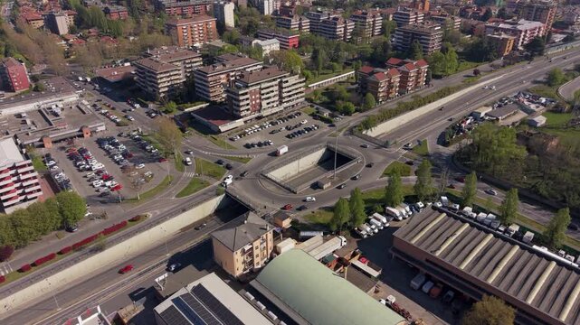 Urban Intersection: An aerial perspective captures a bustling urban intersection, where roadways intertwine amidst buildings and infrastructure, representing the dynamic pace of city life.