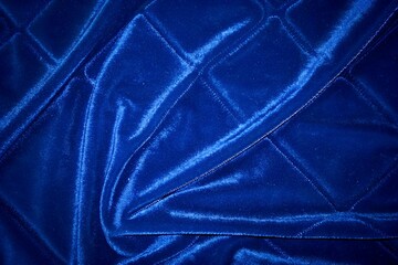 Fototapeta premium luxurious navy blue quilted velvet fabric texture with linear parallel stitching