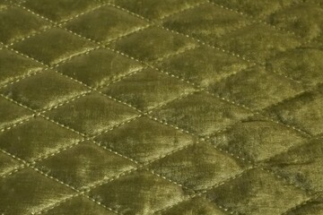 Fototapeta premium luxurious olive green quilted velvet fabric texture with diamond stitch pattern 