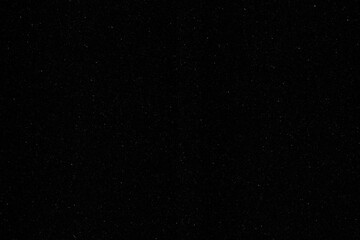 Fototapeta premium A high-contrast, black and white abstract grunge texture background featuring a distressed surface with heavy grain, spots, and scratches, ideal as a vintage overlay or dark, moody backdrop.