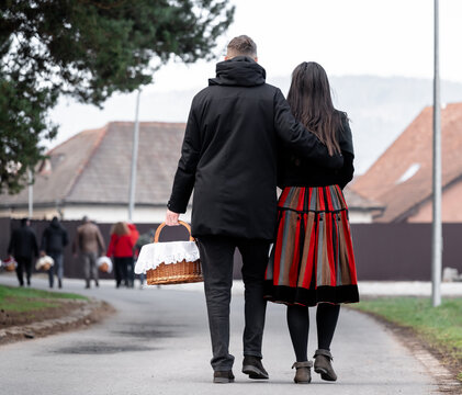 traditional dressed szekler people with easter food basket  