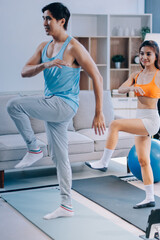 Obraz premium Support, teamwork and fitness couple doing workout training, challenging exercise for endurance, strength and stamina in a gym. Active, fit man and woman giving support and motivation during pushup