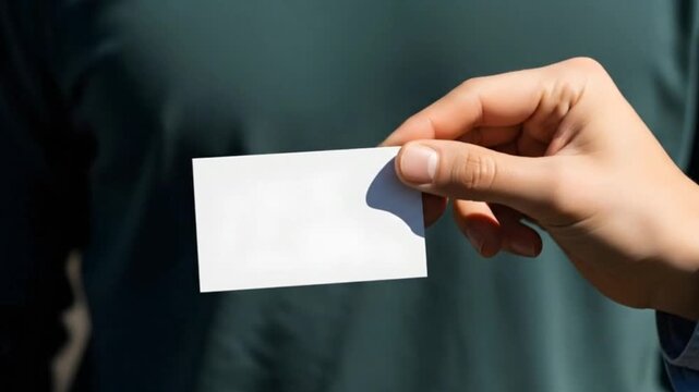 Close up of a man's hand holding a blank white business card mockup for corporate identity