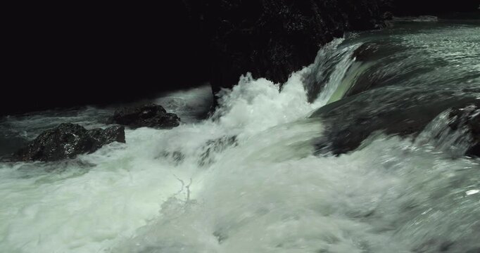 Cinematic Water Flow with Splash Over Rocks in Tropical Canyon
