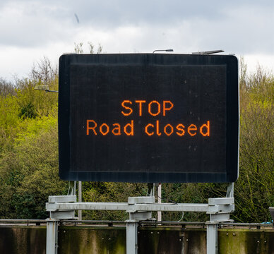 STOP - Road Closed. A motorway overhear matrix sign on a UK Manchester advising motorists the motorway is closed due to an incident.
