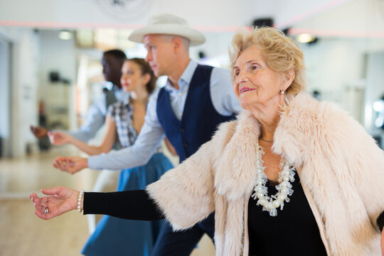 Jazz dancers standing in row and flicking with fingers