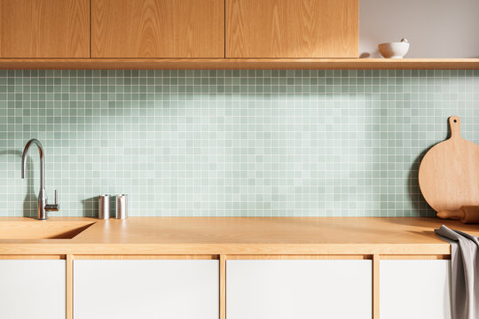 Minimalist kitchen interior with wooden cabinets, mint tile backsplash and clean countertop in modern design style. 3D Rendering