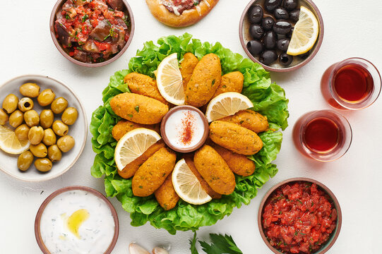 Turkish lentil kofte, mercimek koftesi, served with mezze, top view.