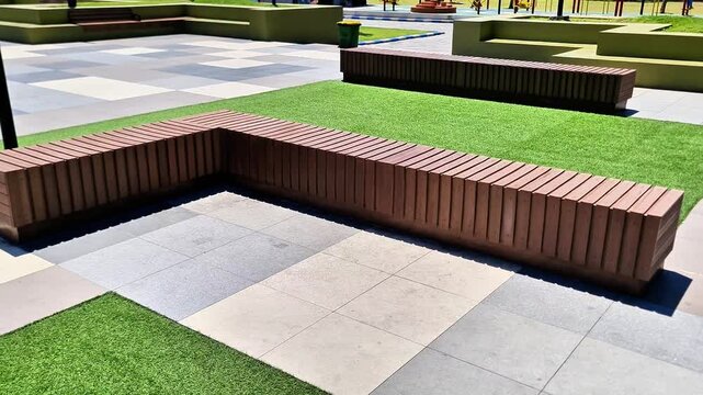 Modern L Shaped Wooden Park Bench on Geometric Pavement in Public City Square