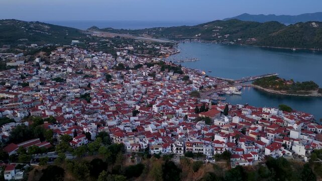 Panoramic summer dusk aerial view of the illuminated town of Skiathos island, Sporades, Greece