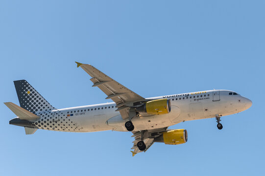 A Vueling airplane flying approaching for landing on 3rd of April of 2026, in Alicante, Spain.