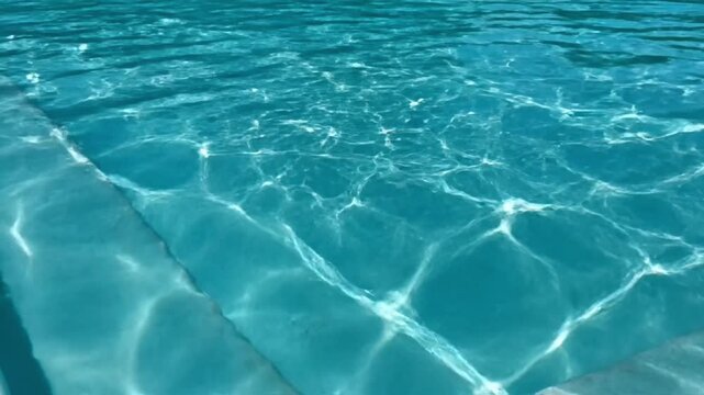 turquoise swimming pool water texture with gentle ripples and reflections