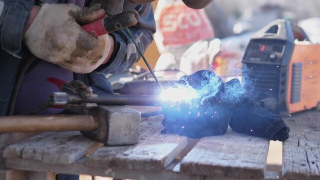 Closeup Arc Welding Pipe Joint, Bright Blue Arc Illuminates Bench And Welding Machine As Gloved Hands Steady Electrode And Sparks Spray, Emphasis On Intense Light And Focused Metalwork.