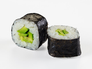 Two fresh avocado maki sushi rolls isolated on a clean white background. © Andrei Starostin