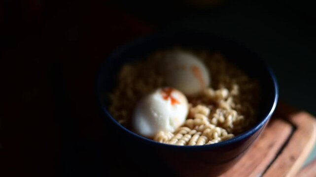 Noodles in a bawl with hard boiled eggs natural authentic light, selective focus food background video