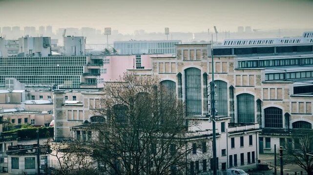 Lyon cityscape with Halle Tony Garnier concert hall and urban buildings in hazy daylight