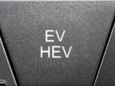 Close up of EV HEV Mode Selector Button on Modern Car Dashboard