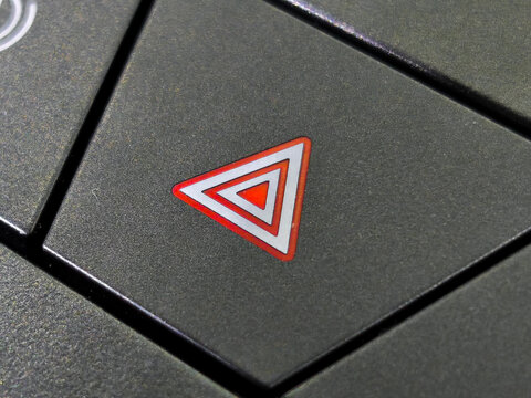 Red Emergency Hazard Warning Flasher Button on Car Dashboard