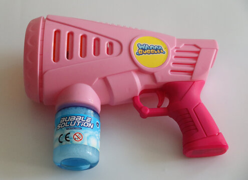 Norwich, England, April 4 2026: Editorial photo. Bright pink bubble gun with solution bottle for kids outdoor fun and playtime entertainment