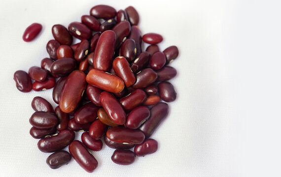 Heap of organic rajma, (Laal Lobia ) or red kidney beans dal cleaned on a white background. Top view. Indian dal, Tadka curry ingredients concept.