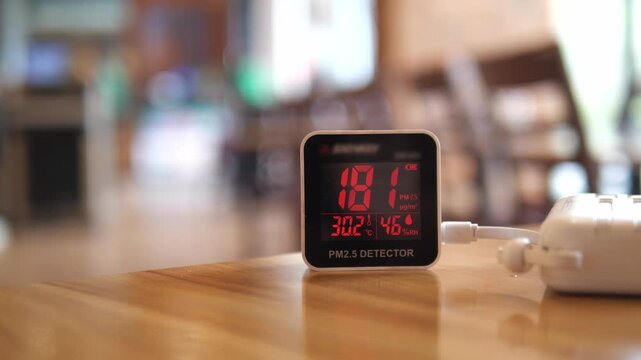 Digital air quality detector showing high hazardous PM 2.5 levels with red warning display for pollution and health concept