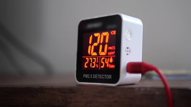 Digital air quality detector showing high hazardous PM 2.5 levels with red warning display for pollution and health concept