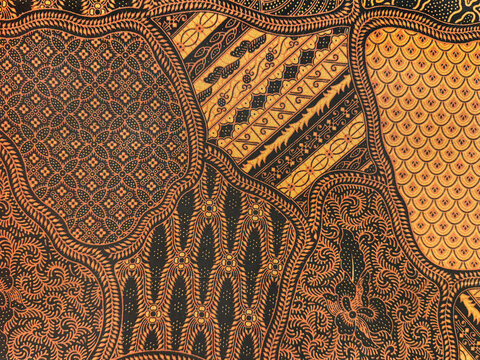 Combination of ethnic ornamental Batik fabric in random cut shape. Various pattern, paisley, and abstract engraved textile design in shades of brown and white color. Seamless background texture.