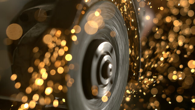 A car tire spins quickly on a road at night. Bright sparks fly around the tire as it moves. The scene shows energy and motion in a dark setting, creating a dynamic look.
