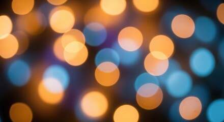 Fototapeta premium Soft-focus image of colorful circular bokeh lights in warm orange and cool blue tones on a dark background.