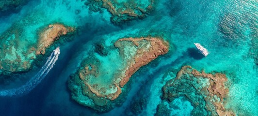 Fototapeta premium Aerial Top View of Tropical Islands and Coral Reef Patterns in Crystal Clear Turquoise Water, Abstract Organic Shapes, Bright Minimal High-Key Seascape with Luxury Travel Concept and Copy Space