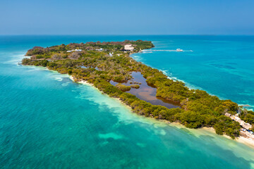 Obraz premium Aerial view of a lush tropical island and coral reefs in the Rosario Islands archipelago, Colombia