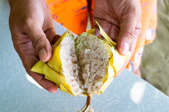 Freshly cooked Filipino puso rice, wrapped in coconut leaves. Puso, or hanging rice, is a traditional Filipino delicacy from Cebu and the Visayas region