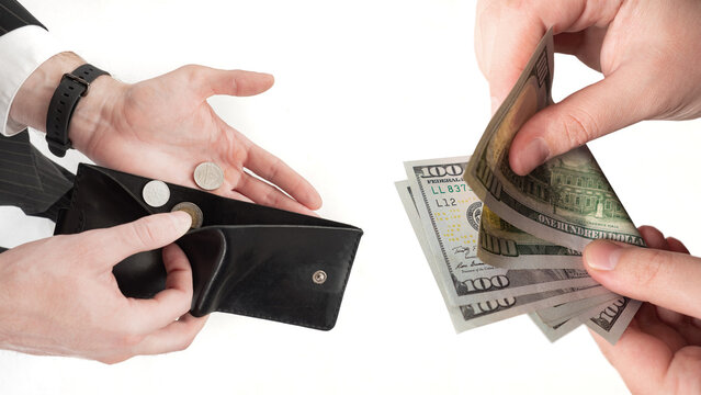 Personal finance inequality, low income and wealth gap concept. Empty wallet with coins contrasts hand holding dollar banknotes, showing financial hardship, budgeting pressure and economic disparity.