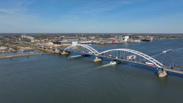 Timelapse of dense traffic on a bridge and river shipping in Europe