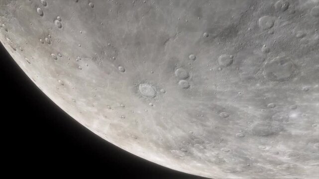 Detailed surface view of the moon showing numerous impact craters and rocky landscape.